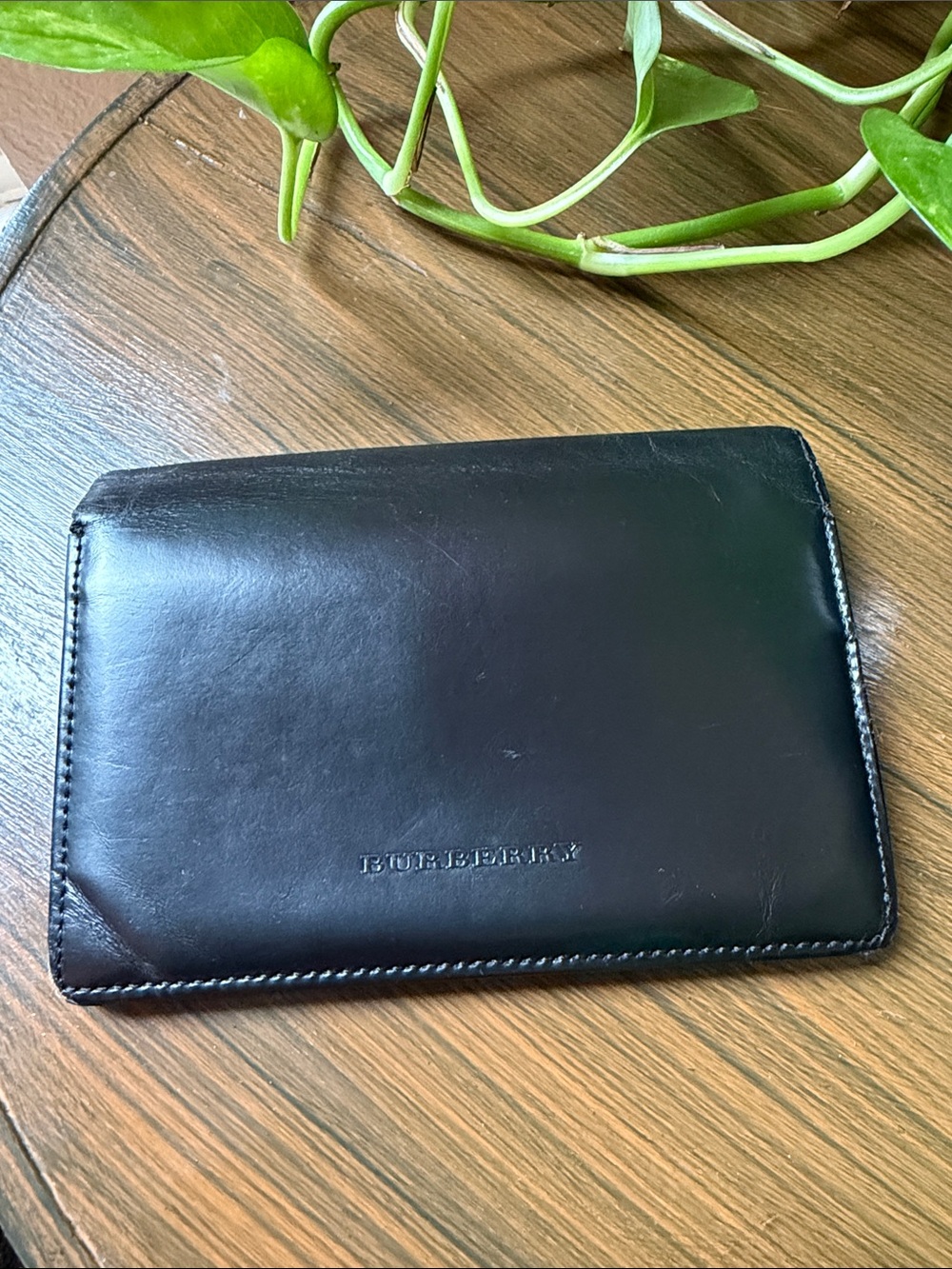 Burberry bifold wallet with an interior coin pocket.